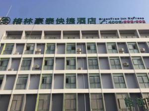 a building with a sign on top of it at GreenTree Inn Heze Shan County Huxi South Road Express Hotel in Heze