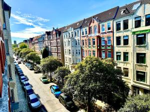a city street with cars parked next to buildings at Schicke Altbauwohnung in Kiel Mitte 24-7 Check In in Kiel