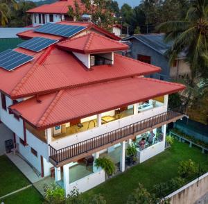 an aerial view of a house with solar panels on the roof at Holiday Home Kalutara in Kalutara