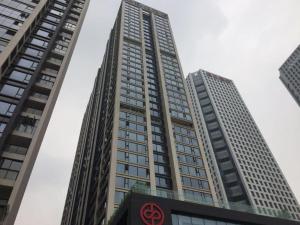 a tall building with a red symbol on it at 7Days Premium Chengdu New Century Global Centre New Exhibiton Branch in Chengdu