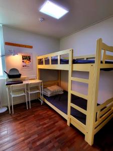 a room with two bunk beds and a desk at 24 Guesthouse Sinchon Avenue in Seoul