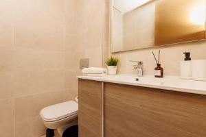a bathroom with a toilet and a sink at Stylish 1BR flat in Hay Riad Central Rabat in Rabat