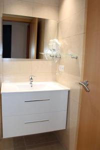 a bathroom with a white sink and a mirror at Residencial Super Stop Apartaments Torre Valentina in Sant Antoni de Calonge