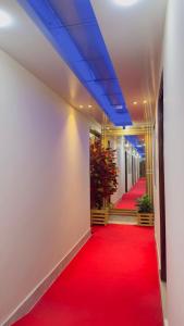 a corridor with a red carpet and blue ceilings at Hotel Blue Sky Mirpur in Dhaka