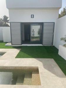 a person standing in the doorway of a house at villa de standing in Sali Nianiaral