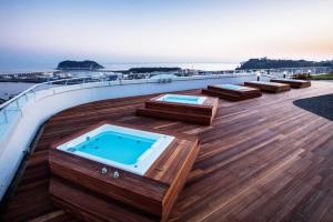 a deck with a hot tub on top of a ship at The Artstay Seogwipo Harbor in Seogwipo