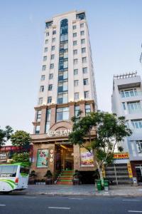 a bus parked in front of a tall building at GIC Land Hotel in Da Nang
