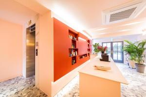 an office lobby with an orange accent wall at Plain Hotel in Chuncheon