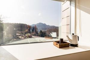 a window with a view of a mountain at Plain Hotel in Chuncheon