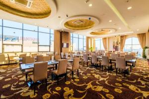a conference room with tables and chairs and windows at GIC Land Hotel in Danang