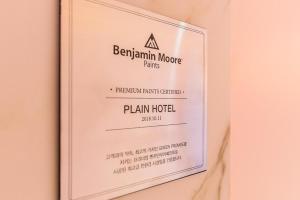 a sign for a benjamin moore parks plan hotel at Plain Hotel in Chuncheon