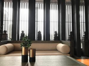 a living room with a couch in front of windows at Tiantai He hotel in Tiantai