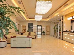 a lobby with couches and chairs in a building at GreenTree Inn Zhangye Ganzhou Train Station Orthopaedic Hospital in Zhangye