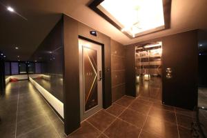 a hallway with a glass door in a building at Hotel Ruvino in Pansong