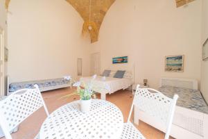 a room with a bed and two chairs and a table at B&B Gallipoli Vecchia in Gallipoli +24 photos