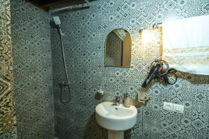 a bathroom with a sink and a mirror at Riad Fes Lile in Fez