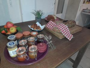 a table with bread and other foods on it at La Maison du Prince de Condé in Charroux-dʼAllier