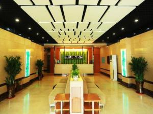 a lobby with benches and plants in a building at Jinjiang Inn Style Linfen Shenglong International Plaza Jiefang Road in Linfen