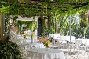 a group of tables and chairs with flowers on them at Reginna Palace Hotel in Maiori