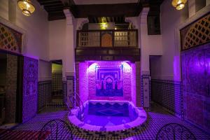 a purple room with a tub in a building at Riad Fes Lile in Fès