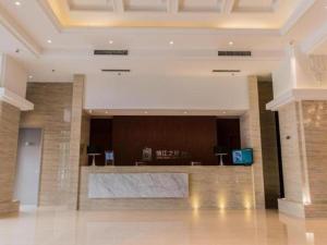 a lobby with a reception desk in a building at Jinjiang Inn Select Hohhot Chengjisihan Square Metro Station in Hohhot
