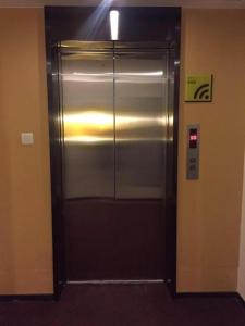 a elevator in a building with a metal door at IU Hotels·Tangshan No.1 Middle School North Youyi Road in Beiziyuan