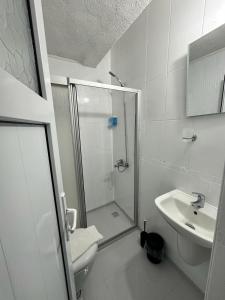 a bathroom with a shower and a toilet and a sink at Denizati Pension in Bodrum City