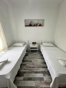 two beds are lined up in a room at Denizati Pension in Bodrum City