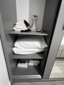 a shelf with a pillow and a lamp in a room at F4 Luxury Stays One bed apartment with Parking in Ilford +16 photos
