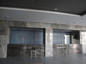a lobby with a bar with stools in it at Jinjiang Inn Select Jiuquan Wanda Plaza in Jiuquan