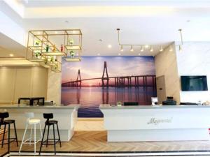 a mural of a bridge on a wall in a room at Magnotel Hotel Qionghai Wanquanhe Aihua Road in Qionghai