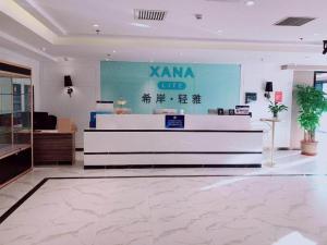 a lobby with a karma club sign on the wall at Xana Lite Beijing Huangcun West Street Metro Station in Daxing