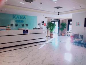 a lobby of a karma club with chairs and tables at Xana Lite Beijing Huangcun West Street Metro Station in Daxing