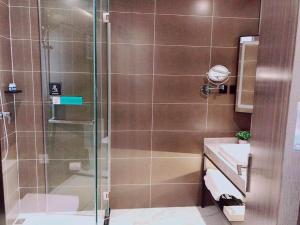a bathroom with a shower and a sink at Xana Lite Beijing Huangcun West Street Metro Station in Daxing