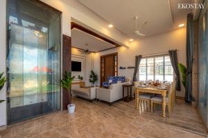 a living room with a couch and a table at Ekostay Cliffside Villa I Mountain View in Lonavala +20 photos