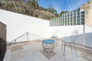 two chairs and a table on a patio at La maison de Lili aux portes du Luberon in Cavaillon