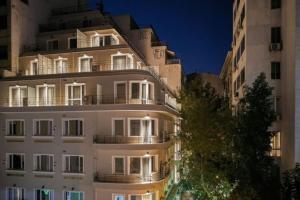 a large white building at night with lights at Viola Comfort Suite in Athens