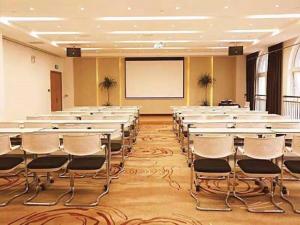 a conference room with white tables and chairs and a whiteboard at James Joyce Coffetel·Anyang Text Museum in Anyang