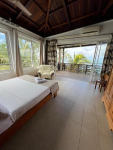 a bedroom with a bed and a view of the ocean at Blue Bay Beachfront 3 bedrooms Penthouse in Blue Bay