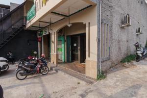 une moto garée devant un bâtiment dans l'établissement KoolKost near Stasiun Poris Tangerang, à Porisgaga
