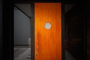 a wooden door with a round window on it at Yufuin Luxury Villa -zakuro- in Yufuin