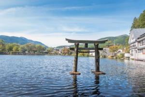a torii gate in the middle of a lake at Yufuin Luxury Villa -zakuro- in Yufuin