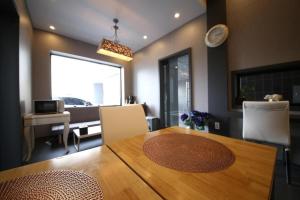 a dining room with a table and a living room at Best In City Hotel in Daejeon