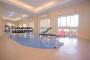 a large room with a gym with a treadmill at Kara's Condotels Cebu in Cebu City