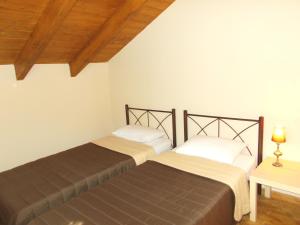 two beds sitting next to each other in a room at Porto Katsiki Blu in Athani