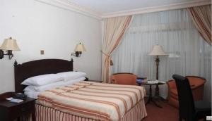 מיטה או מיטות בחדר ב-Rachael Hotel