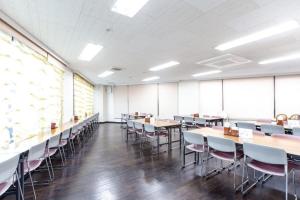 a large room with tables and chairs in it at OYO Sun Hotel Kokubu Kagoshima in Kirishima