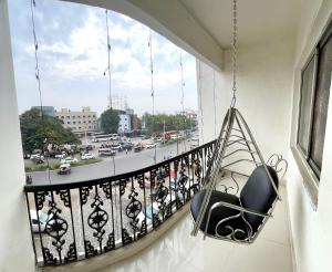 a balcony with a chair and a view of a street at Hotel Sai Chhatra in Shirdi