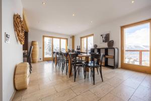 a dining room with a table and chairs at Chalet Enchanteur in Nendaz