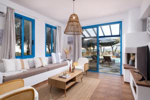 a living room with a couch and a table at Blue Waves Villa by Nomads in Kissonerga